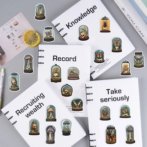 Detail of vintage science-style stickers featuring bottled mushrooms and insects on notebooks