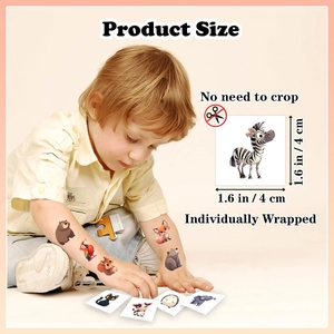 Close-up of 1.6 inch waterproof animal tattoo stickers on a child hand and product packaging