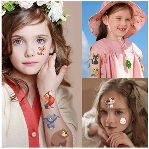 Close-up of cute cartoon animal temporary tattoos applied to child face and arm for party