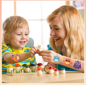 Waterproof cartoon monster temporary tattoo applied on child arm in home setting