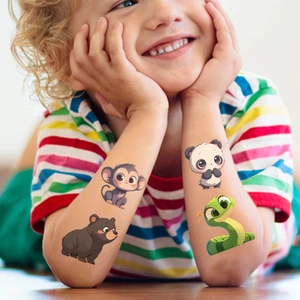 Close-up of colorful cartoon animal temporary tattoos on a child's arm for parties