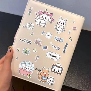 Close-up of cute cartoon animal stickers on a beige leather notebook cover for DIY scrapbooking