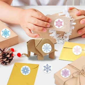 Roll of assorted colorful snowflake stickers for gift wrapping and envelope sealing