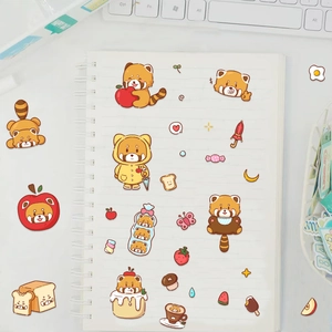 Cute red panda stickers shown on a white spiral notebook with creative stationery decor