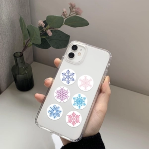 Close-up of clear phone case with blue and pink snowflake patterns on a hand-held device