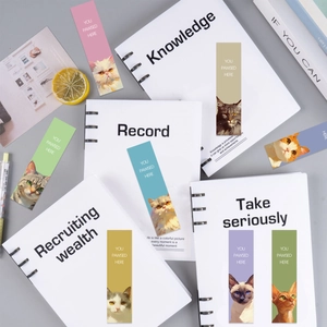 Set of 8 cute cartoon cat bookmarks with YOU PAWSED HERE text on a notebook background