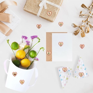 Vintage heart-shaped wooden stickers on gift boxes and envelopes with floral decor