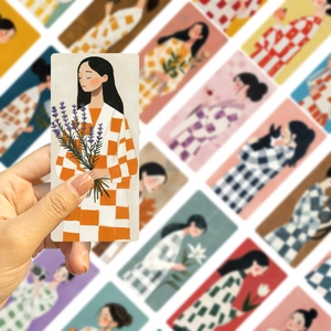 Artistic close-up of cartoon girl bookmarks with creative watercolor floral illustrations