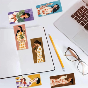 Artistic bookmarks with cute girl illustrations on a creative stationery desktop setting