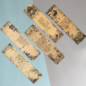 Close-up of retro Gothic bookmarks with black ink skull designs and kraft paper texture