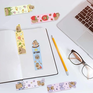 Detailed close-up of six Capybara themed paper bookmarks in a cozy desk setting