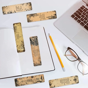Close-up of vintage kraft paper bookmarks with dark gothic illustrations and quotes