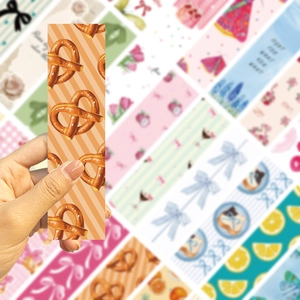 Detail of a paper bookmark with a pretzel design on an orange striped background