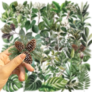 Close-up of waterproof PET sticker featuring realistic pine cone and green needle designs