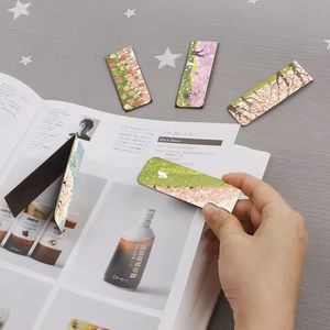 Close-up of magnetic bookmarks with Japanese floral designs on a magazine page