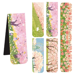 Macro view of magnetic bookmarks with spring floral illustrations and soft pastel colors
