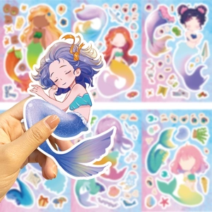 Detail of glittery mermaid sticker with blue tail held in hand for kids DIY craft