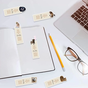 Detail of dog-themed bookmarks with inspirational quotes among office accessories