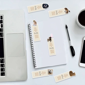 Close-up of animal bookmarks on a desk with a notebook, pen, and coffee
