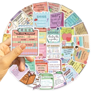 Close-up of waterproof mental health stickers with hand holding a positive quote decal