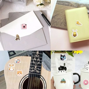 Detailed application of cartoon PVC stickers on notebook, mug, guitar and envelope