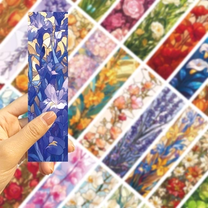 Detailed close-up of floral paper bookmarks with artistic purple iris and rose designs