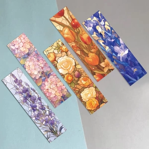Detail showing five different stained glass style floral bookmarks on a two-tone background