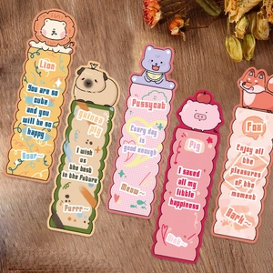 Detail shot of five cartoon animal bookmarks with quotes on a rustic wooden table surface
