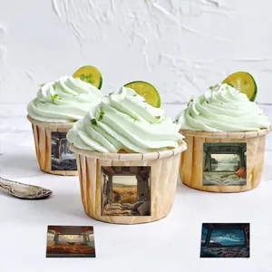 Detail of camping style stickers on cupcakes featuring scenic nature landscapes and greenery