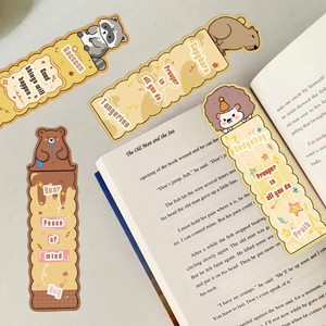 Detailed view of creative animal bookmarks with motivational quotes on a vintage book