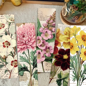 Macro detail of vintage floral bookmarks with retro script texture on matte paper cards