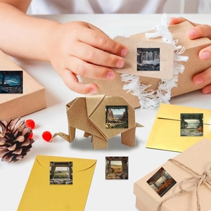 Detail of square camping theme stickers featuring landscapes on kraft paper background