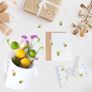 Bee stickers applied on gift boxes and envelopes with a stylish marble background