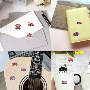 Detail showing fire truck stickers applied to envelopes, journals, and mugs