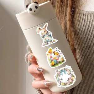 Close-up of Easter stickers with cartoon bunnies and chicks on a white thermal water bottle