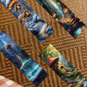 Detailed view of forest bookmarks with fairy tale illustrations on a woven mat background