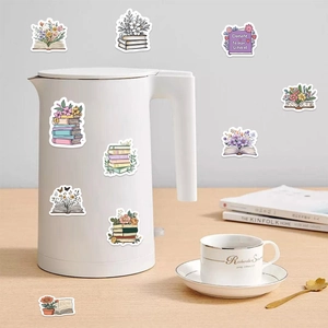 Floral book decorative stickers on a white kettle in a cozy lifestyle setting