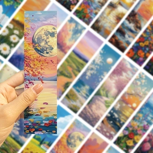 Close-up of artistic oil painting bookmarks with romantic moon and lake landscape scene