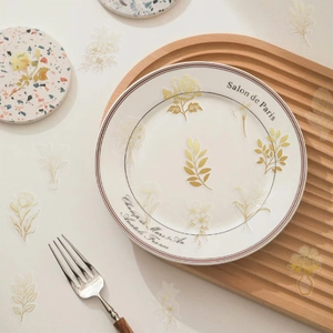 Macro detail of transparent botanical stickers with elegant gold foil floral patterns