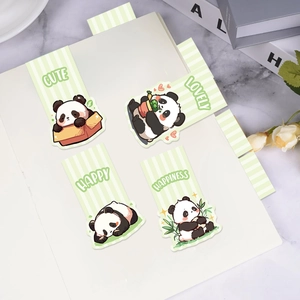 Set of four cute panda magnetic bookmarks on a green striped notebook page
