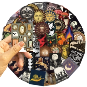 Close-up of vintage celestial stickers featuring sun, moon, and ghost illustrations