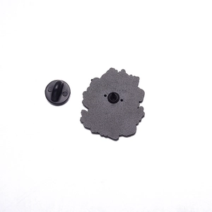 Detail view of the metal enamel pin back with black rubber clutch and textured finish