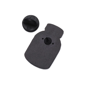 Detail view of the black frosted metal badge back with a secure black rubber clutch