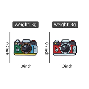 Macro view showing two vintage camera enamel pins with 1.0 x 0.7 inch size details