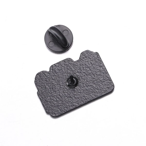 Detailed macro view of the black plated pin back and rubber clutch for camera enamel pin