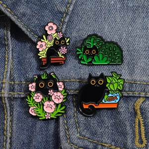 Set of 4 cute black cat enamel pins featuring plants and flowers on denim fabric