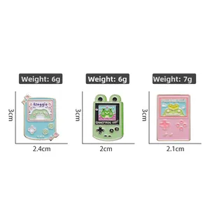 Detailed set of cartoon frog enamel pins in blue, green, and pink handheld game styles