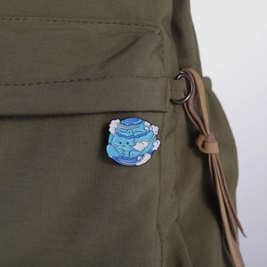 Blue planet cat enamel pin badge accessory on olive canvas bag for decoration