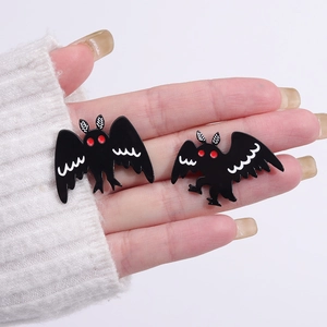 Detail of gothic moth enamel pins with red eyes and white wings for Halloween costumes