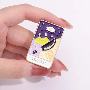 Enamel tarot pin featuring cartoon frog and death card design in gold metal finish